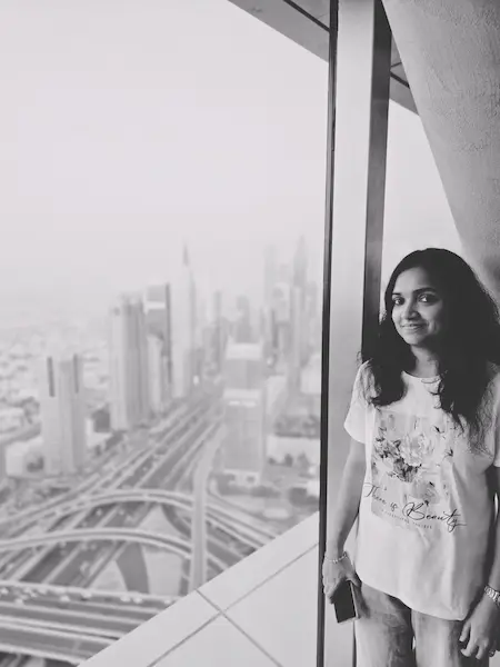 Certified Digital Marketing Freelancer Malappuram standing by a window with city skyline view